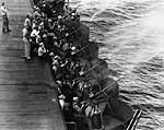 New 20mm guns on Enterprise CV-6 fire at a towed target off Hawaii, March 1942.