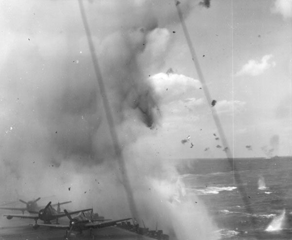 A Kamikaze explodes just off Enterprise's port quarter, 11 April 1945.