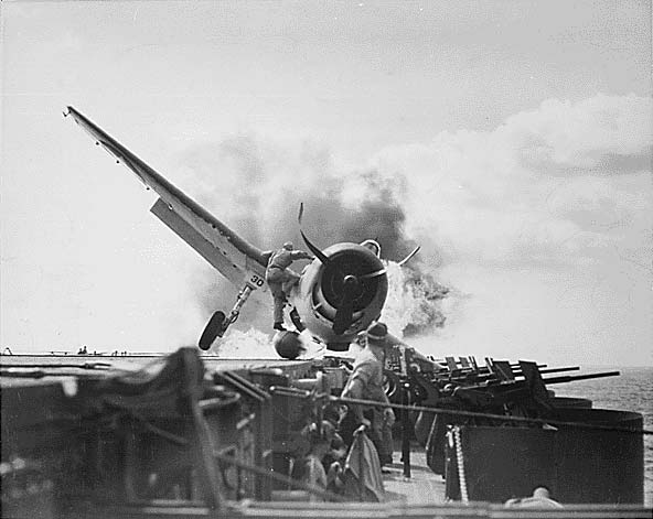 A VF-6 Hellcat afire following an emergency landing aboard Enterprise CV-6, 10 November 1943.