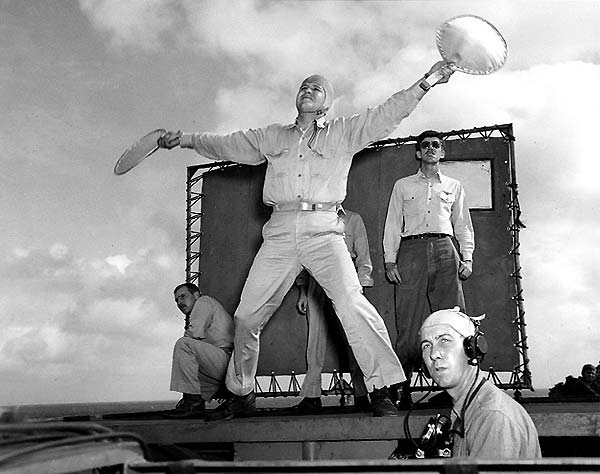 Landing Signal Officer (LSO) ENS Robert H. Grant at work, March 1945.