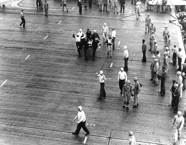 A wounded aircrewman from Yorktown's VB-3 is carried down Enterprise's flight deck.